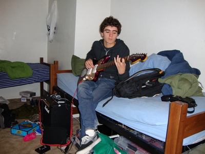 Alec plays guitar in dorm room