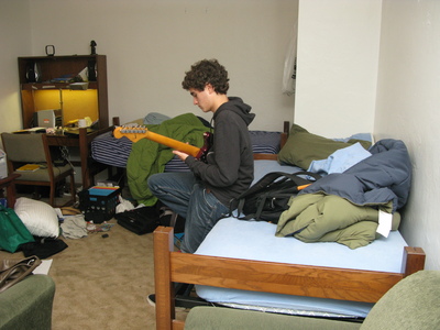 Alec plays guitar in dorm room