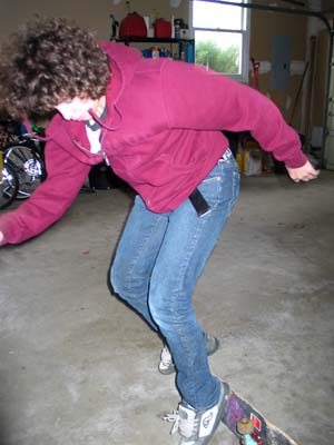 Alec skateboarding in the garage.