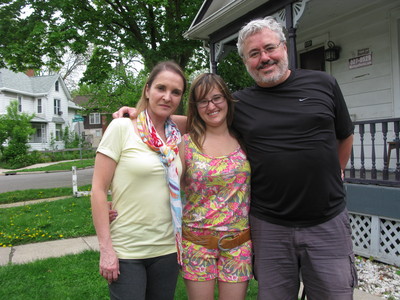 Sasha with her parents in front of her home in Ann Arbor